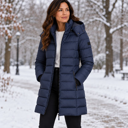 Navy long hooded puffer coat in a snowy park