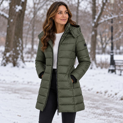 Green long hooded puffer coat in a snowy park